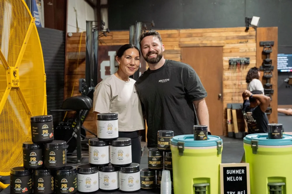 Dre and David Kopp at a NorthStar Fitness Co pop-up table